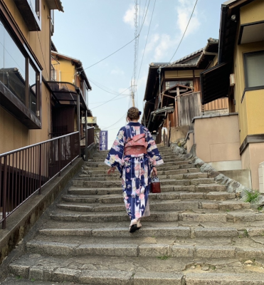 Me in a yukata walking up stairs in traditional Kyoto